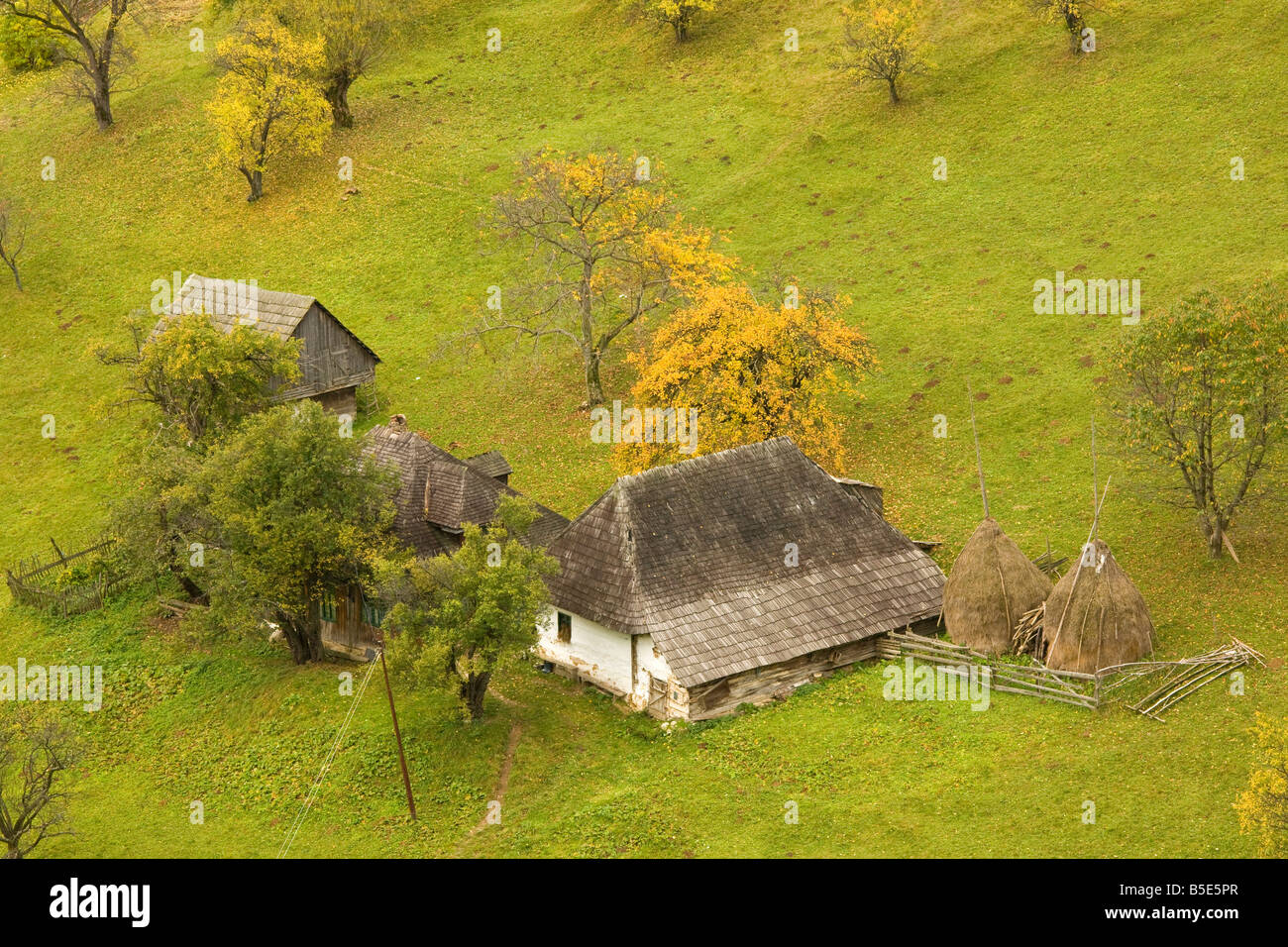 La antigua granja en un hermoso paisaje de bosques montanos pastoral con la agricultura tradicional en Magura Piatra Criaulu montañas Foto de stock