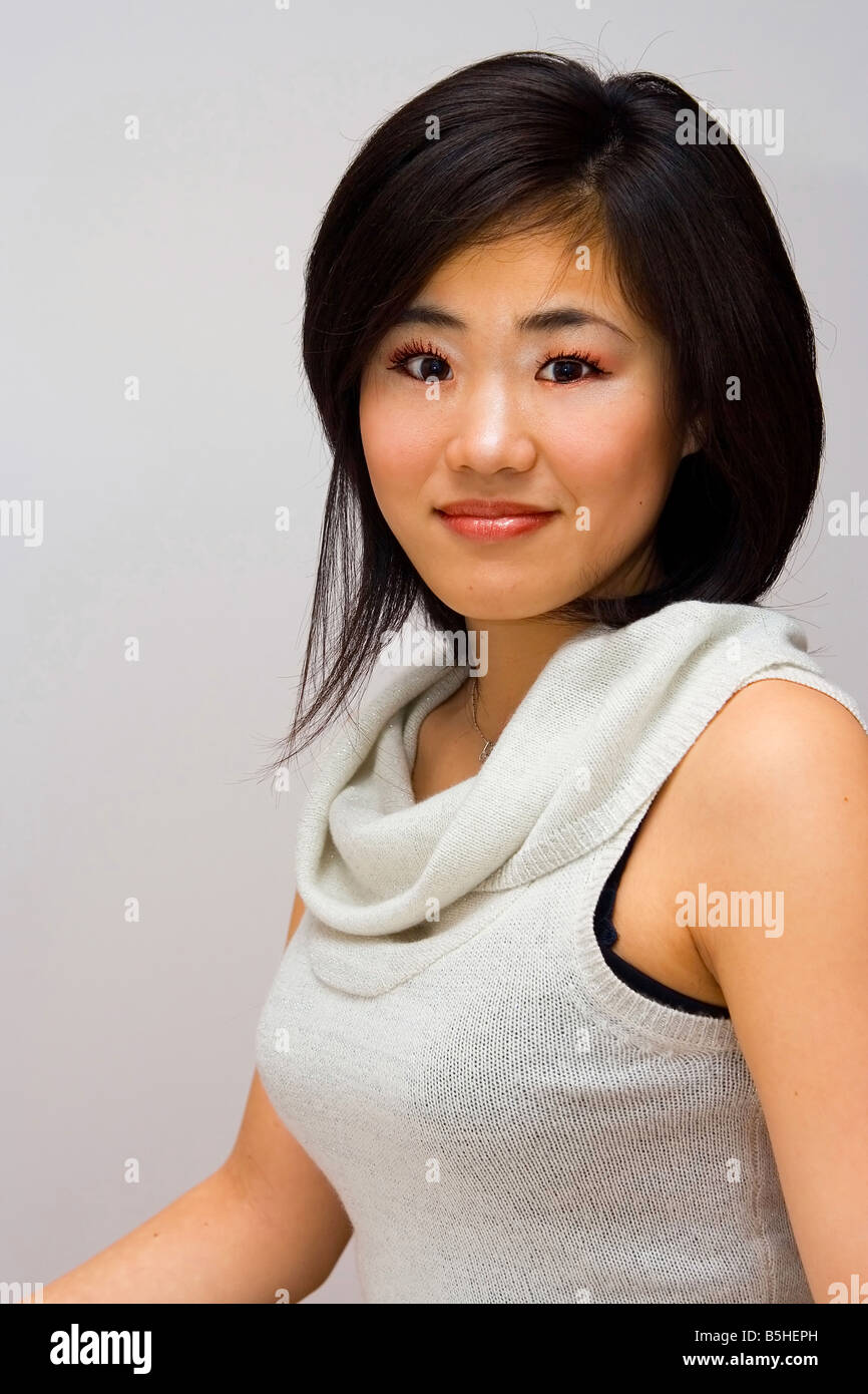Bella mujer Oriental en una camisa con cuello blanco Foto de stock