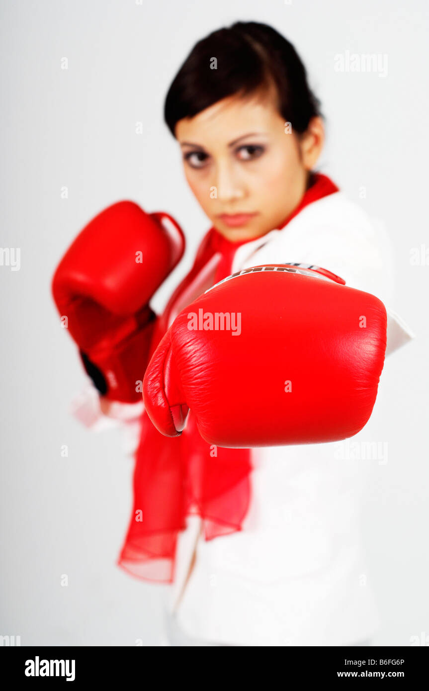Profesional joven mujer de negocios usando guantes de boxeo Foto de stock