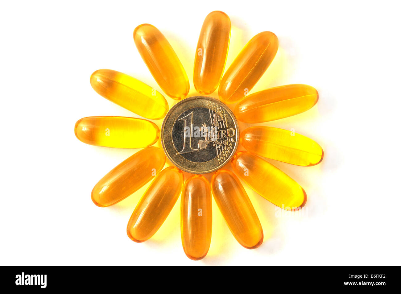 Medicina pastillas, cápsulas formando una flor en un anillo alrededor de una moneda Foto de stock