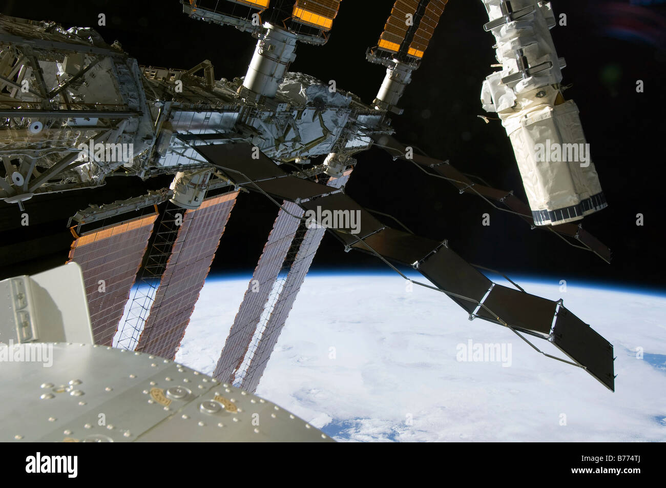 El efector final del brazo robot del emprendimiento aparece entre elementos de la Estación Espacial Internacional. Foto de stock