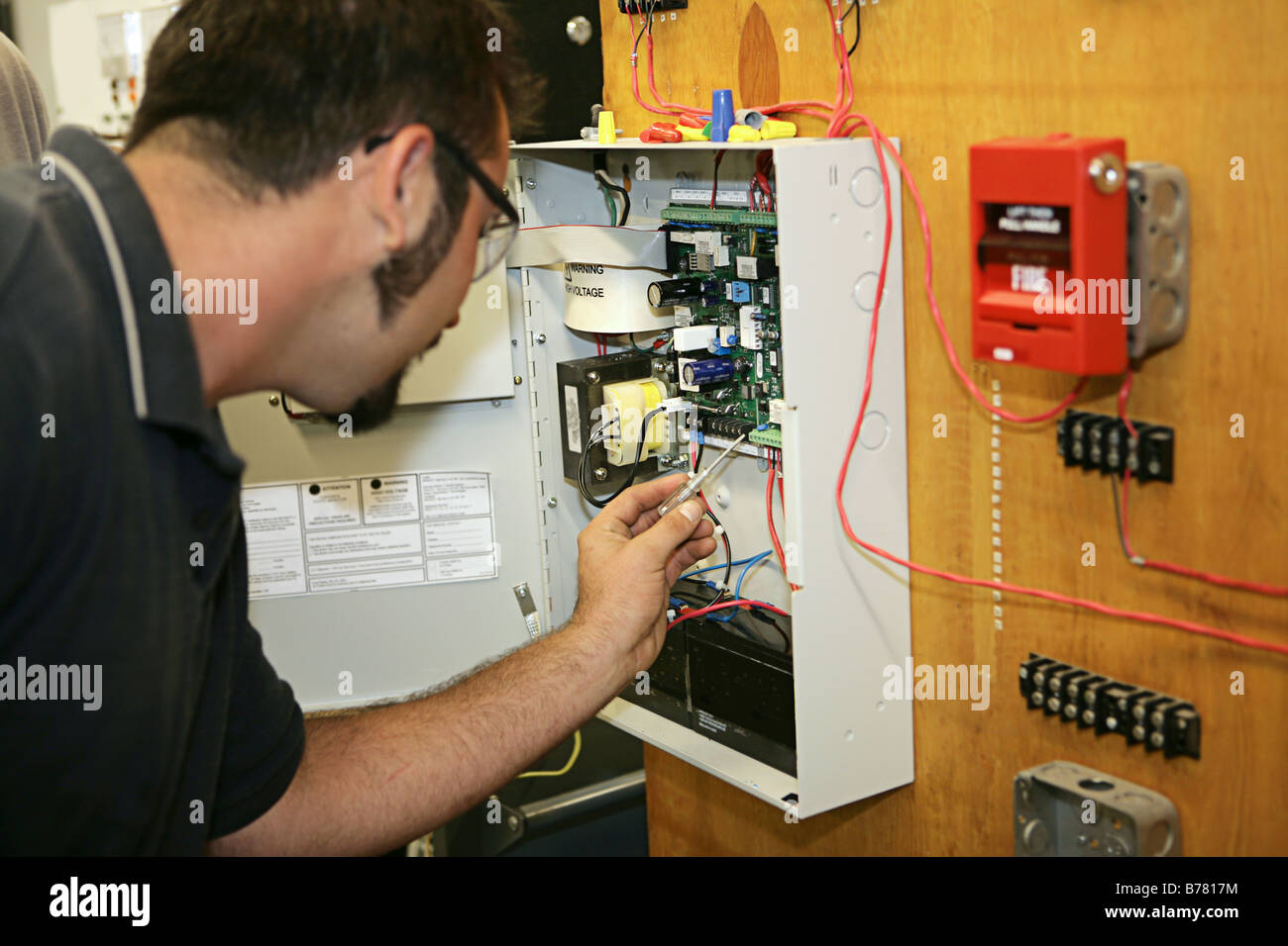 Un estudiante electricista cableado de un sistema de alarma contra  incendios en su colegio técnico Fotografía de stock - Alamy