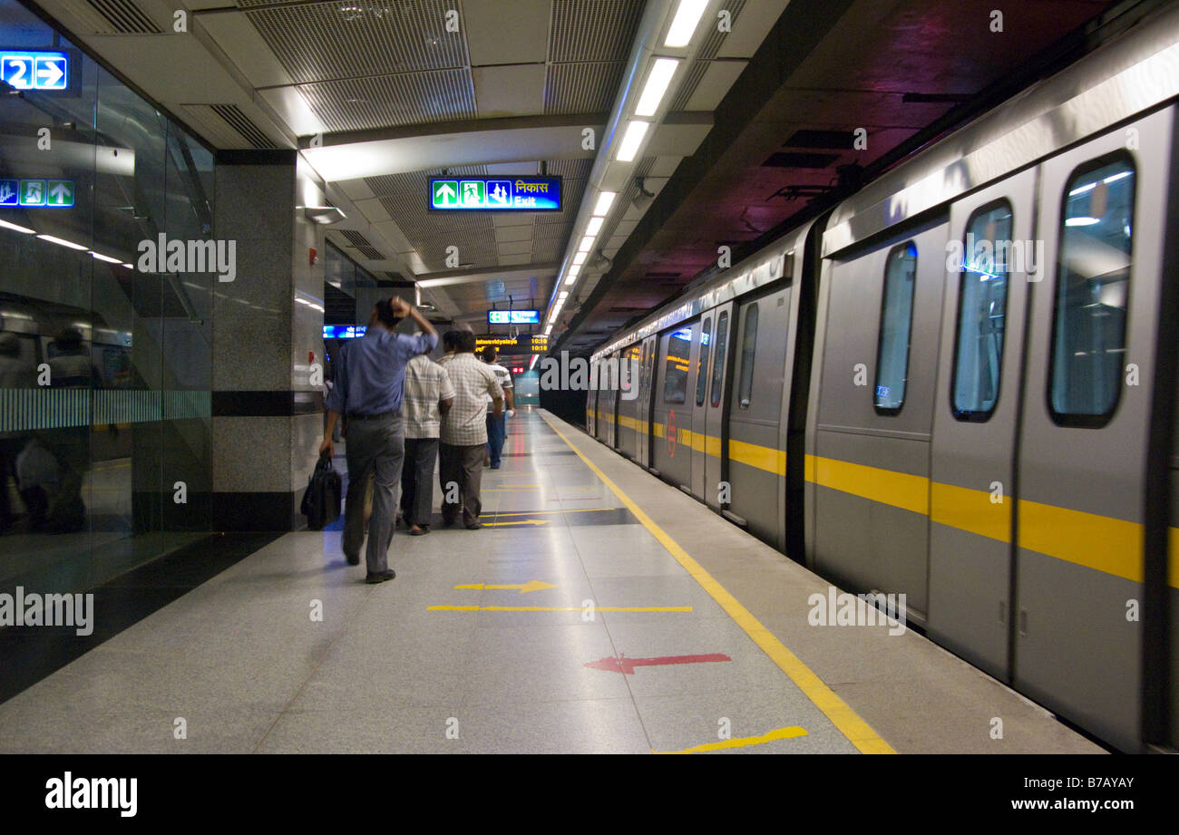 Un tren de la línea amarilla en la plataforma, y algunos pasajeros, en Chandni Chowk estación del sistema de Metro de Delhi. Delhi. La India. Foto de stock