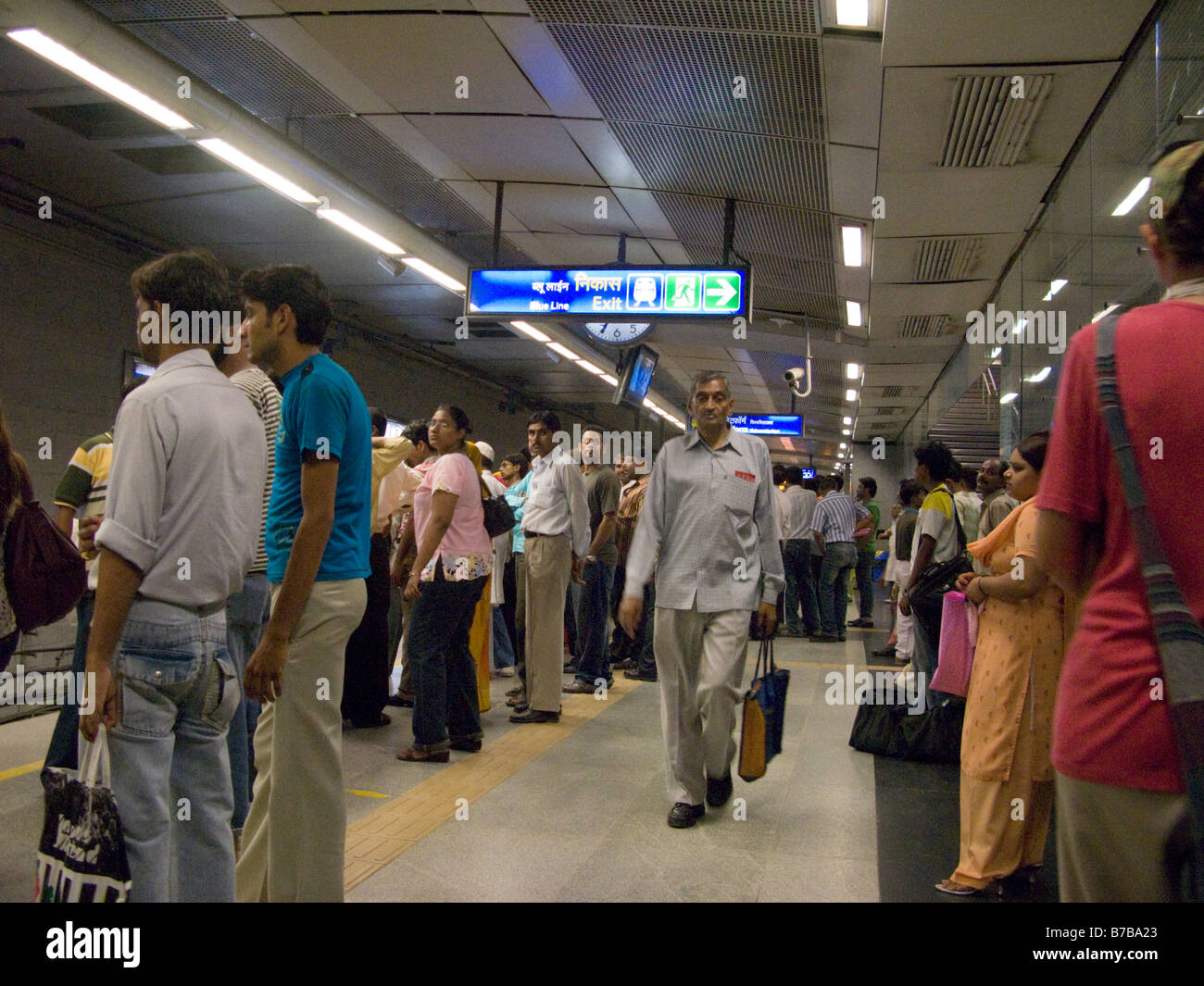 Una plataforma con los pasajeros esperan la llegada de un tren en la Delhi Metro rail system. Delhi. La India. Foto de stock