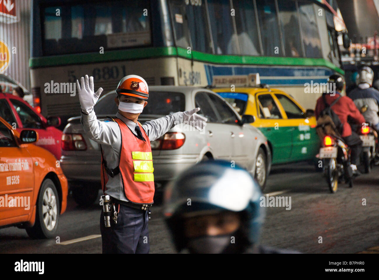 Aparcacoches dirigiendo el tráfico pesado Pathumwan distrito central de Bangkok Thailand Foto de stock