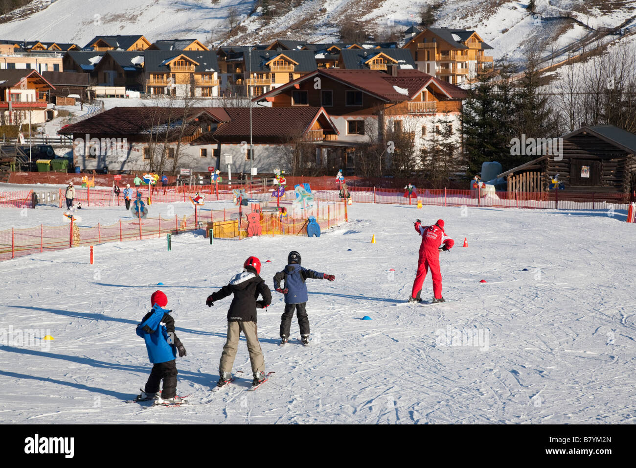 Los niños que aprenden en la escuela de esquí en laderas viveros resort alpino en Alpes austríacos en invierno. Rauris Austria Europa Foto de stock