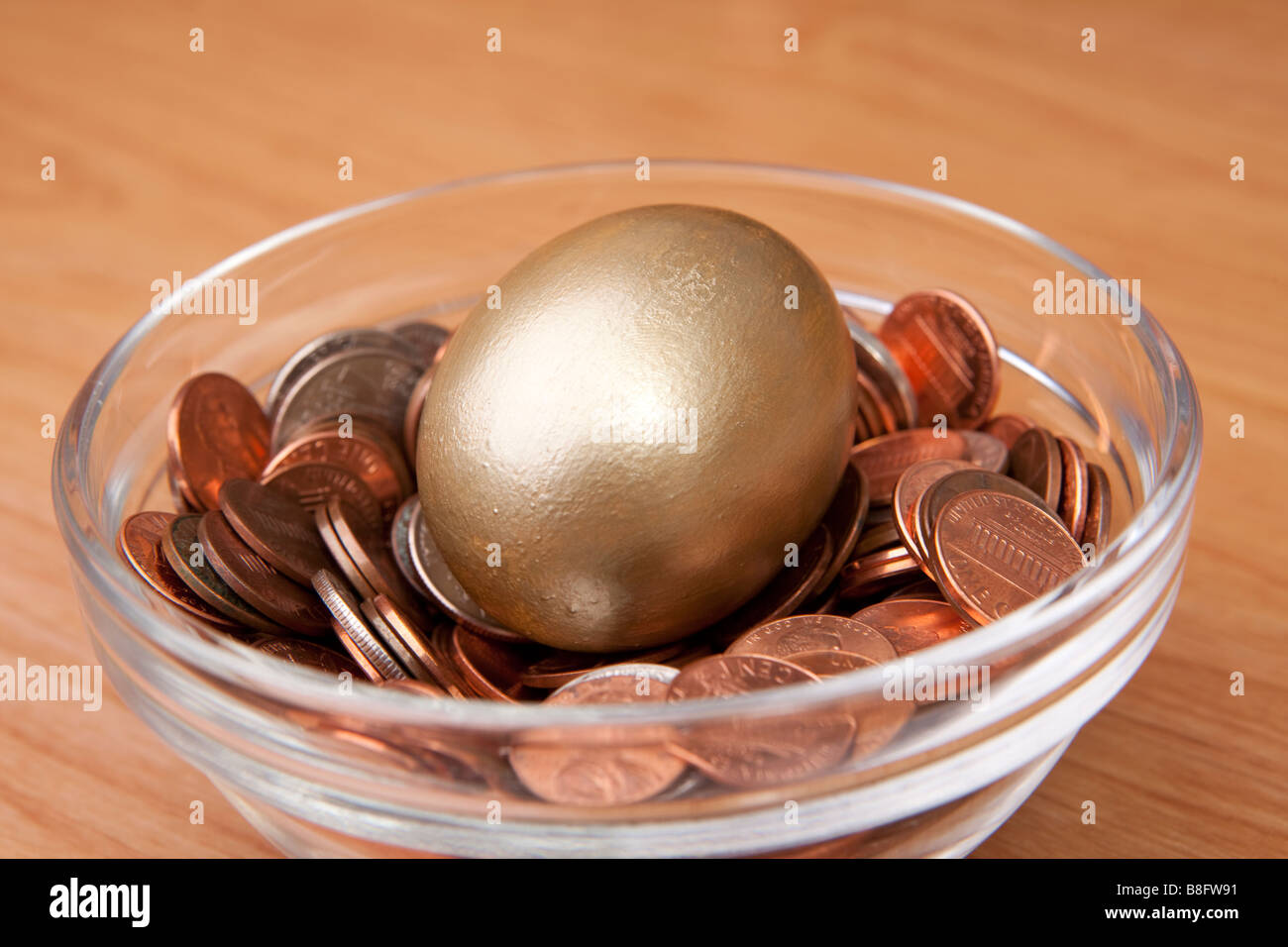 Un huevo de oro en un nido de monedas americanas Foto de stock