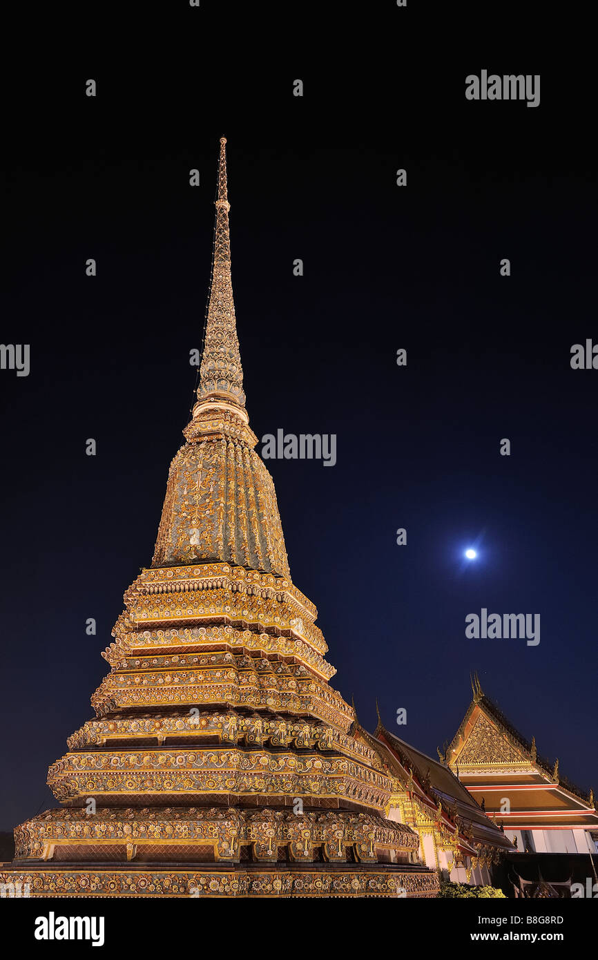 Chedis durante la noche en los locales del templo de Wat Pho, Bangkok, Tailandia Foto de stock