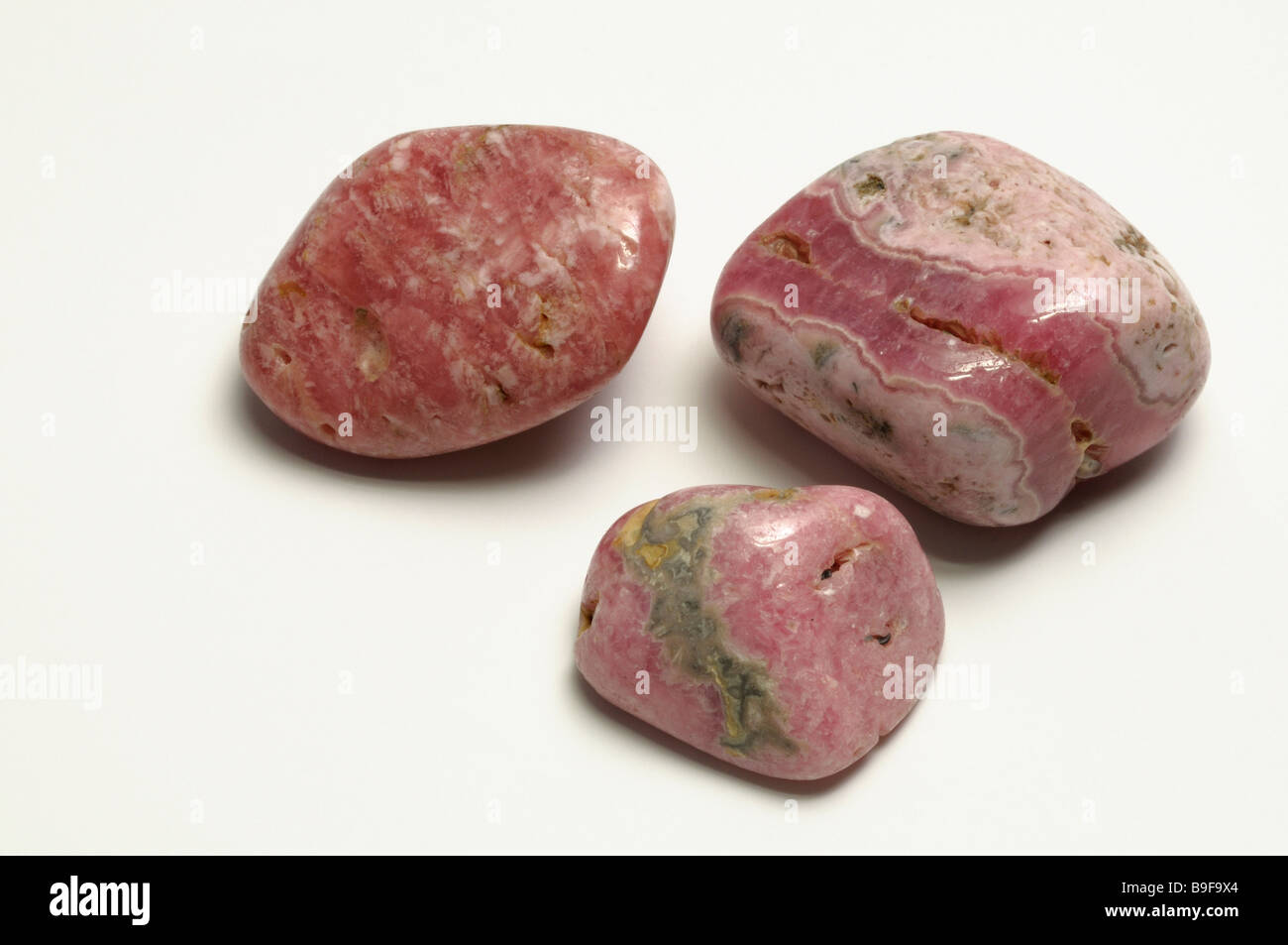 Rodocrosita, tres piedras pulidas, studio picture Foto de stock