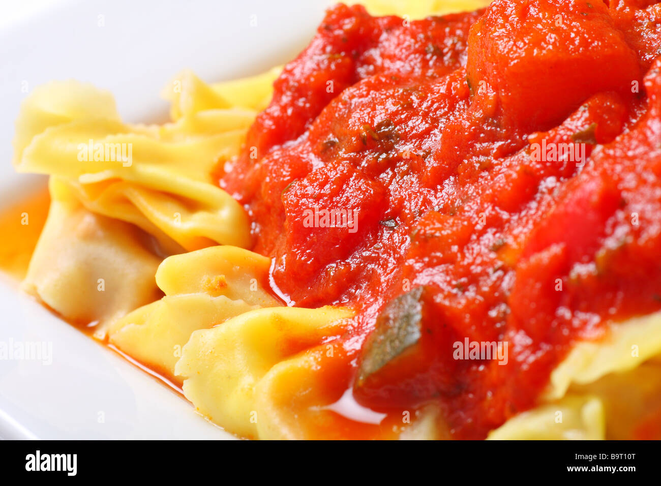 Preparado tortellini con trozos de verduras en salsa de tomate Foto de stock