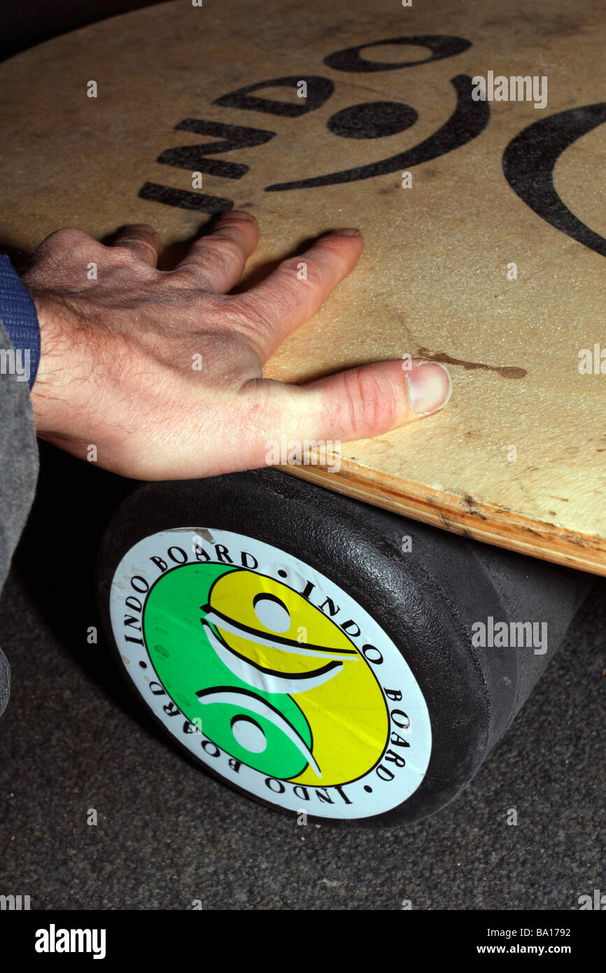 Indo Board balance trainer closeup Dispositivo de ejercicio de equilibrio  con la mano en el rodillo de la junta Fotografía de stock - Alamy