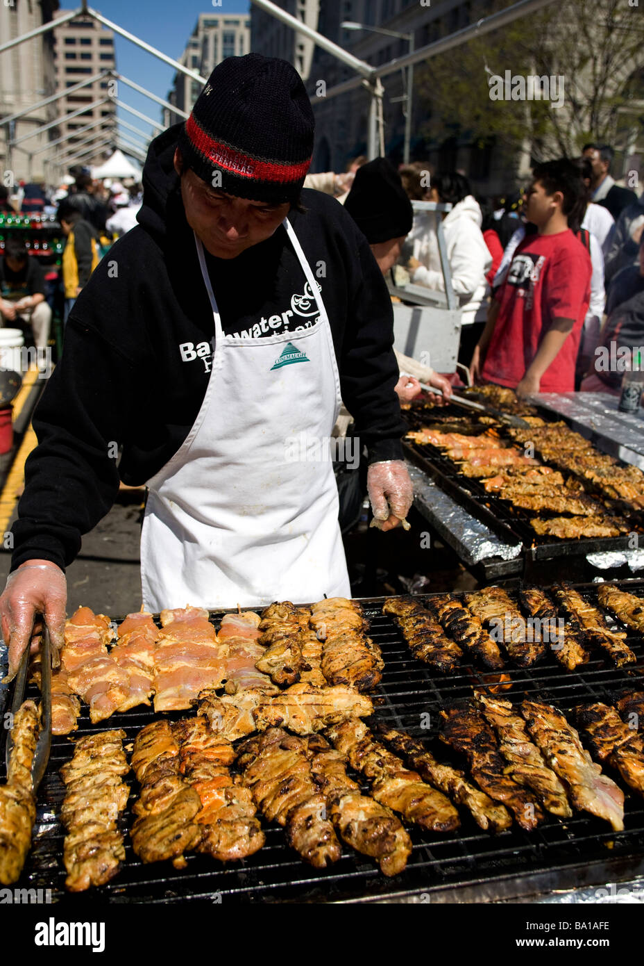 El hombre tiende barbacoa en un festival al aire libre - EE.UU. Foto de stock