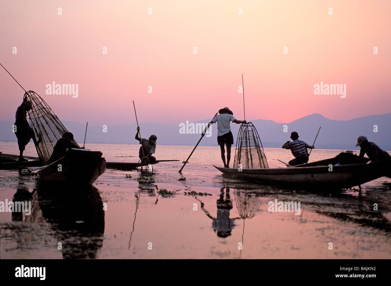 Myanmar (Birmania), el Estado de Shan, el Lago Inle, los pescadores con una gran canasta de pesca cónico al atardecer Foto de stock