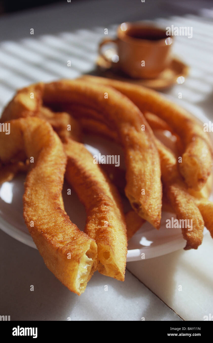 Churros con chocolate, una especie de embudo pastel servido con una taza de  chocolate caliente, close-up Fotografía de stock - Alamy