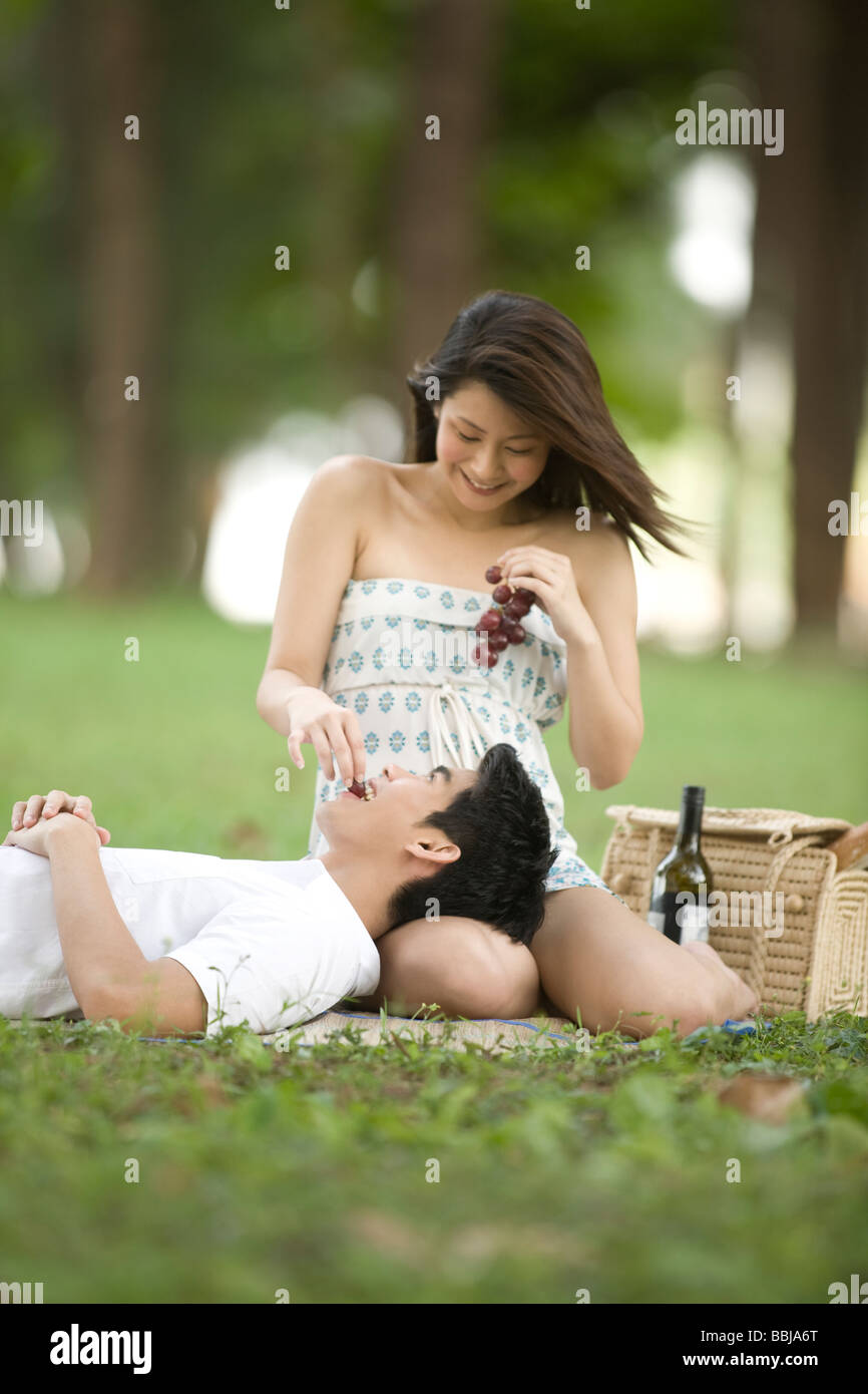 Pareja joven tener un picnic en el parque Foto de stock