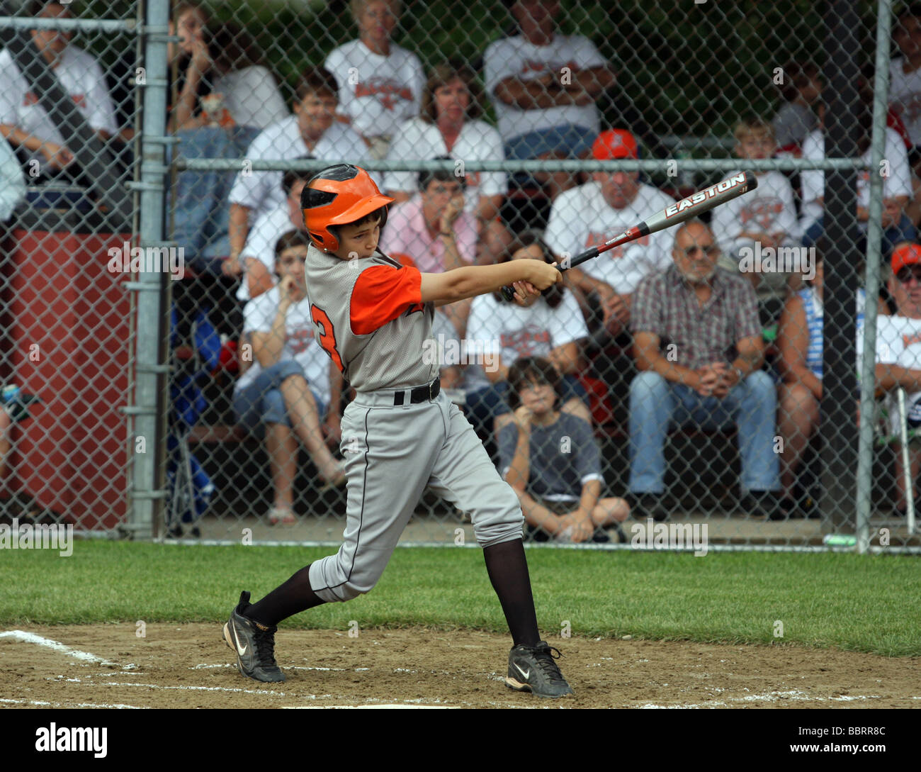 Un jugador de béisbol de la Liga Pequeña hace un golpe durante un partido de liga de verano en Connecticut, EE.UU. Foto de stock