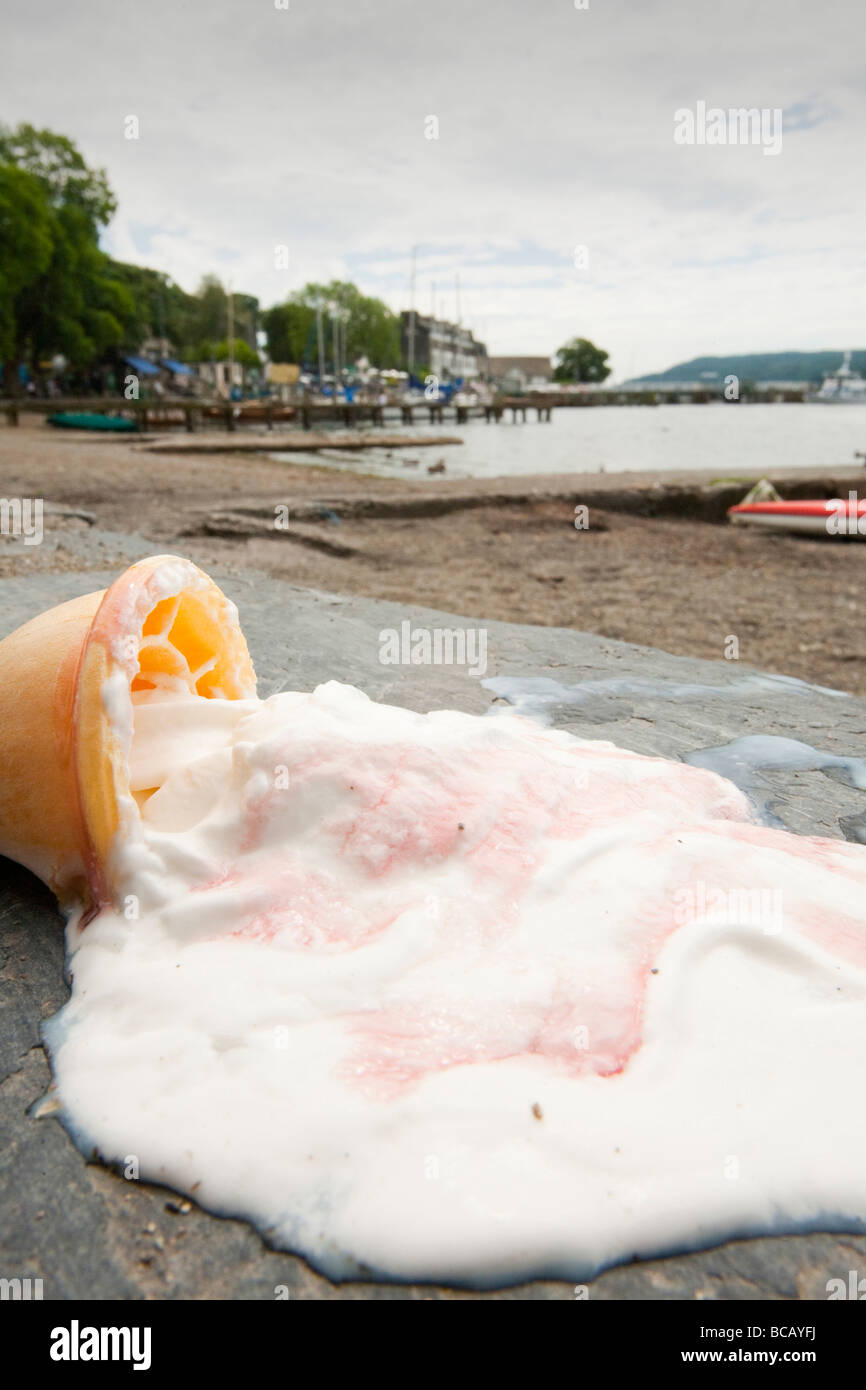 Fusión de un helado en las orillas del lago Windermere Cumbria Reino Unido durante una ola de calor del verano Foto de stock