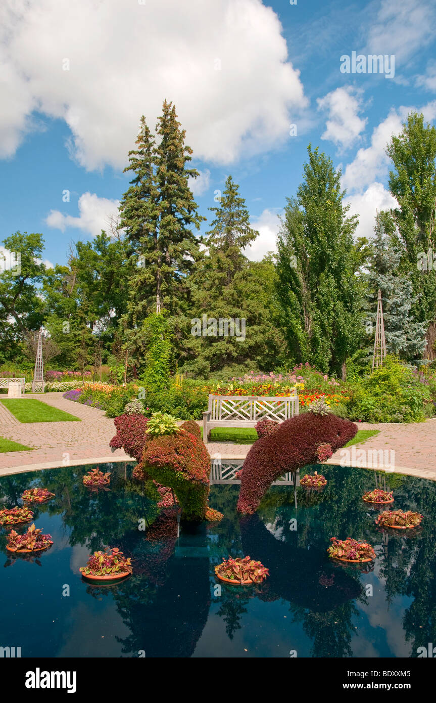 Una piscina con delfines decorativos esculturas en los jardines ingleses de Assiniboine Park en Winnipeg, Manitoba, Canadá. Foto de stock