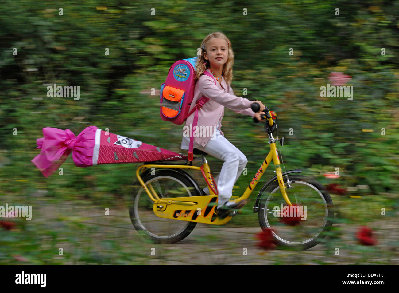 Niña de seis años con el primer día de escuela-corneta en su bicicleta  Fotografía de stock - Alamy