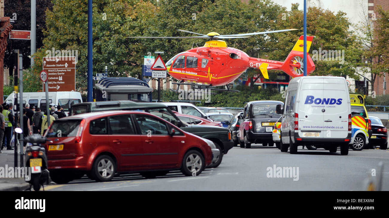 La región de West Midlands de ambulancia aérea helicóptero activables a baja altura sobre el centro de la ciudad de Birmingham, Reino Unido Foto de stock