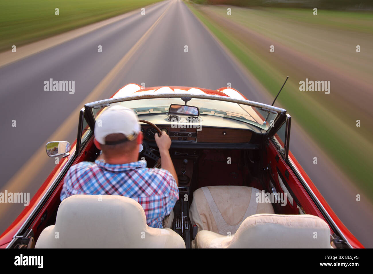 Captura de movimiento borrosa del hombre convertible de conducción Foto de stock