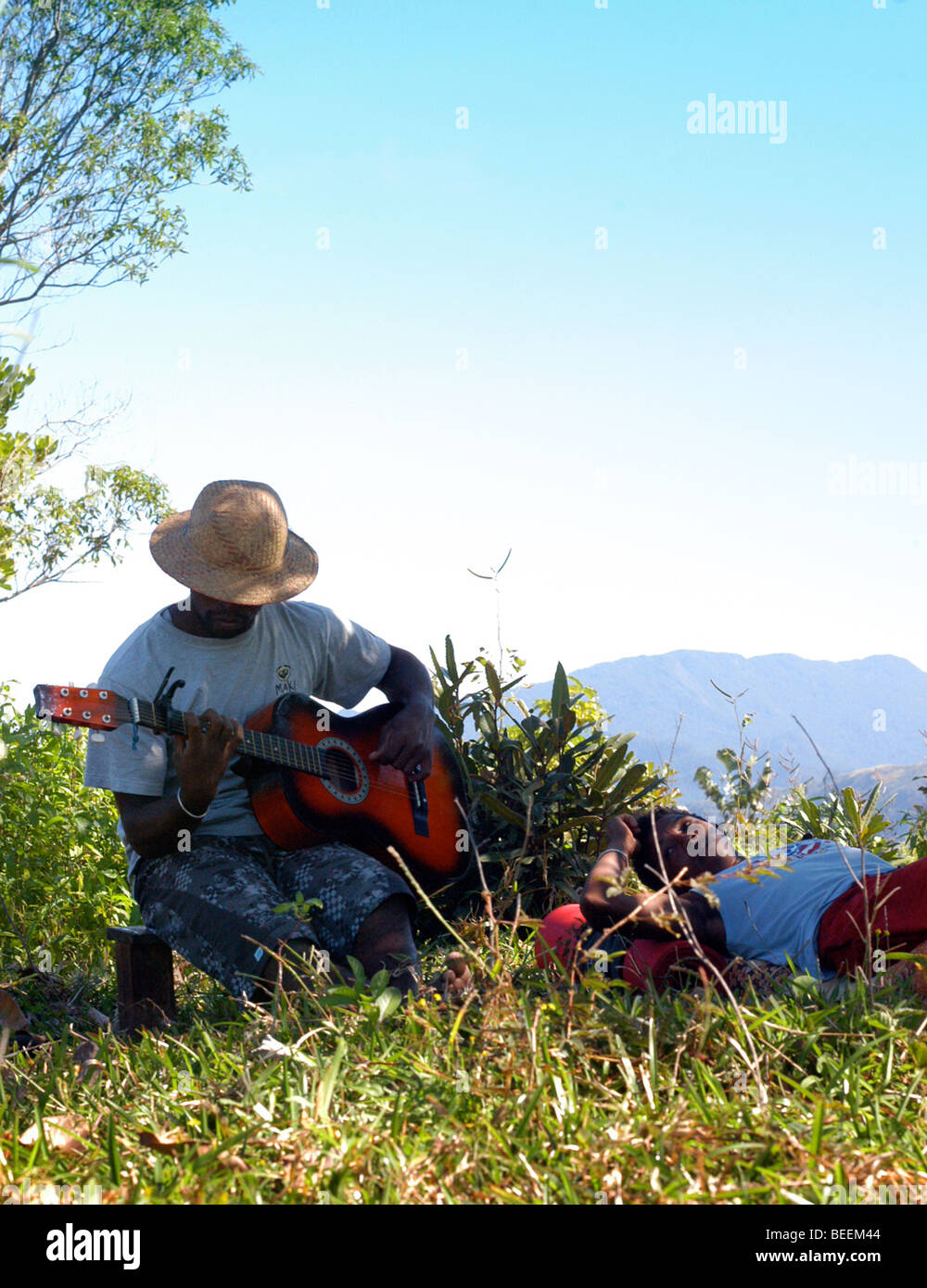 Madagascar - Tocar una guitarra, mientras espera para un paseo de vuelta a  la aldea de Anosy Agnena Fotografía de stock - Alamy