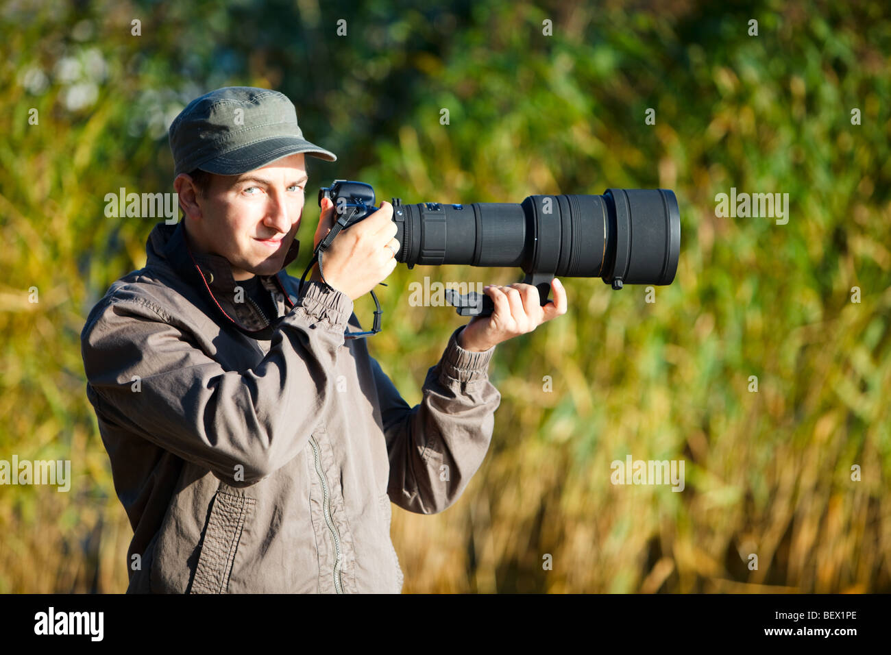 Joven fotógrafo de la naturaleza con la toma de fotografías con teleobjetivo  Fotografía de stock - Alamy