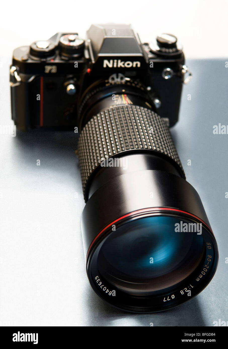 Una visión artística de una cámara Nikon F3 con un lente largo conectado. Foto de stock