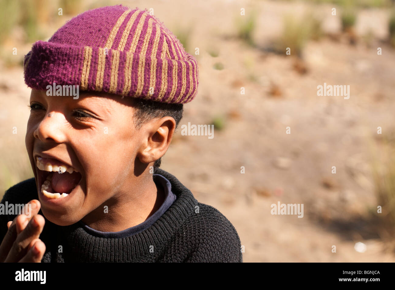 Los jóvenes egipcios con tapa de rayas riendo Foto de stock