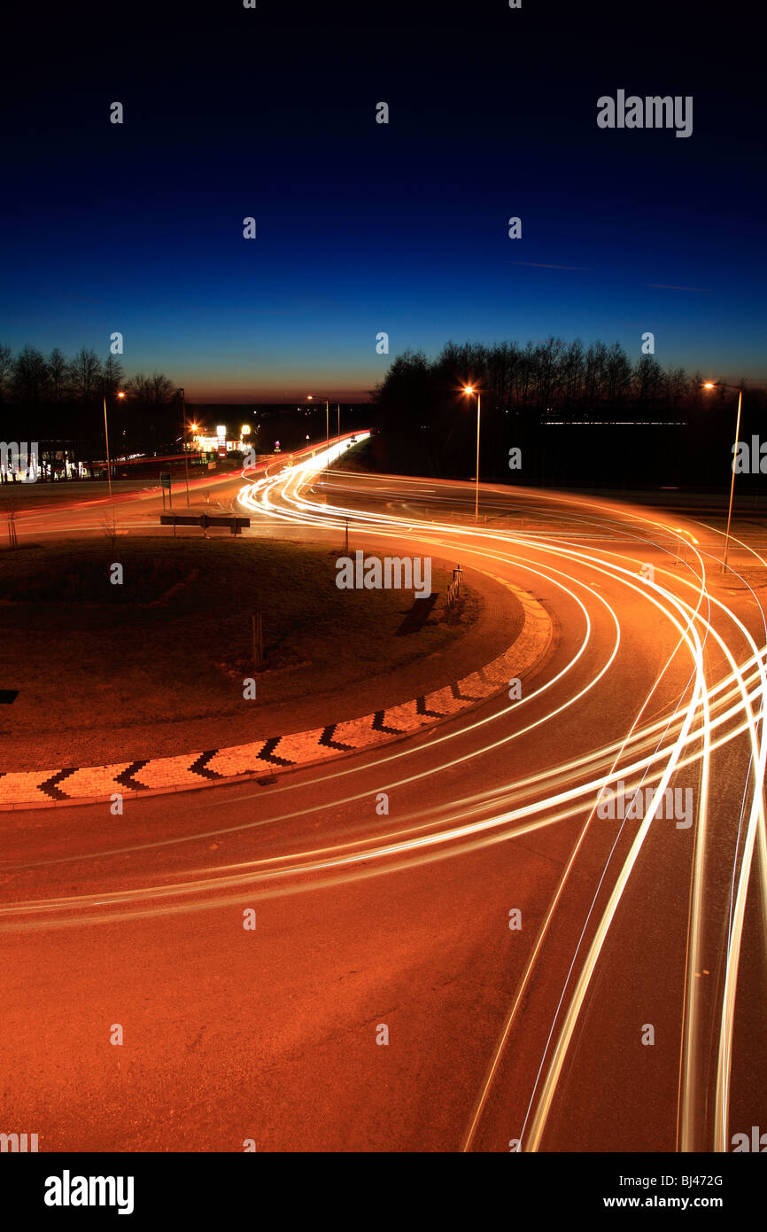 El tráfico de automóviles y estelas de luz en una rotonda. Foto de stock