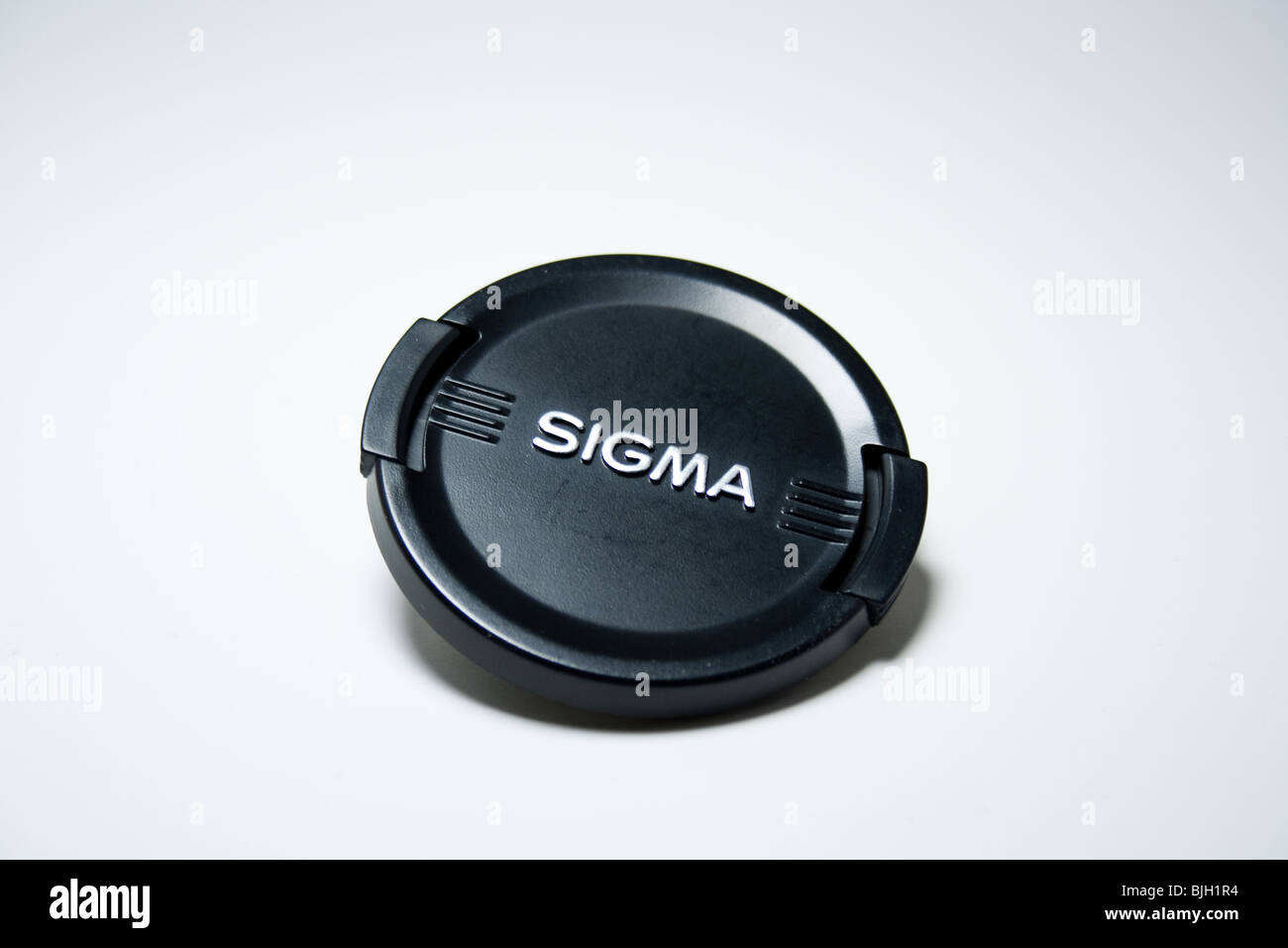 Tapa de lente lente sigma negro logotipo de marca closeup macro producto Foto de stock