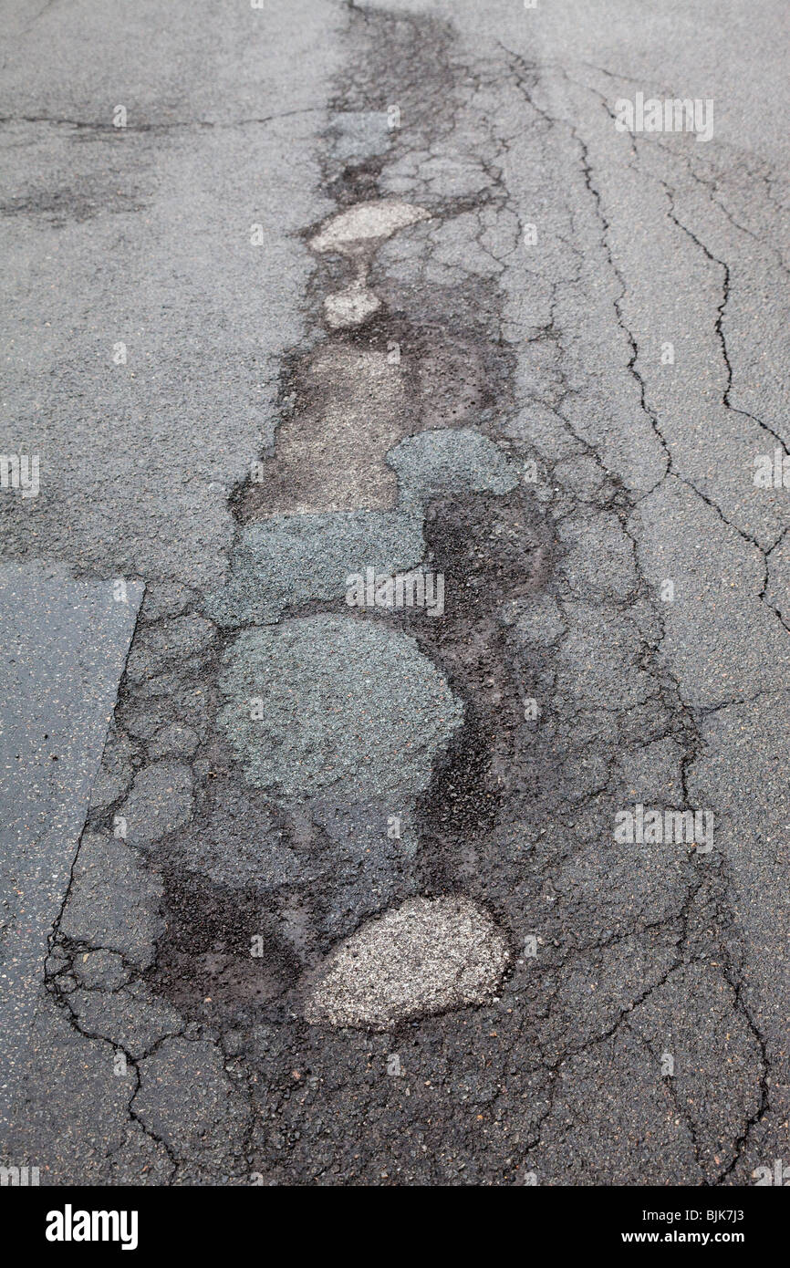 El asfalto agrietado por la escarcha y el frío, los baches en Berlín, Alemania, Europa Foto de stock