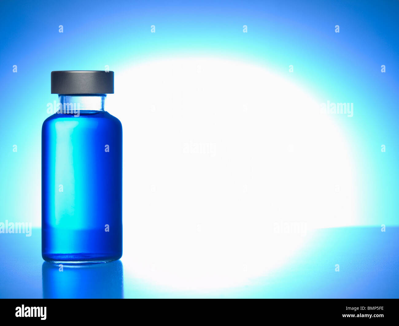 Cerca de una ampolla llena de líquido azul. Copie el espacio. Foto de stock