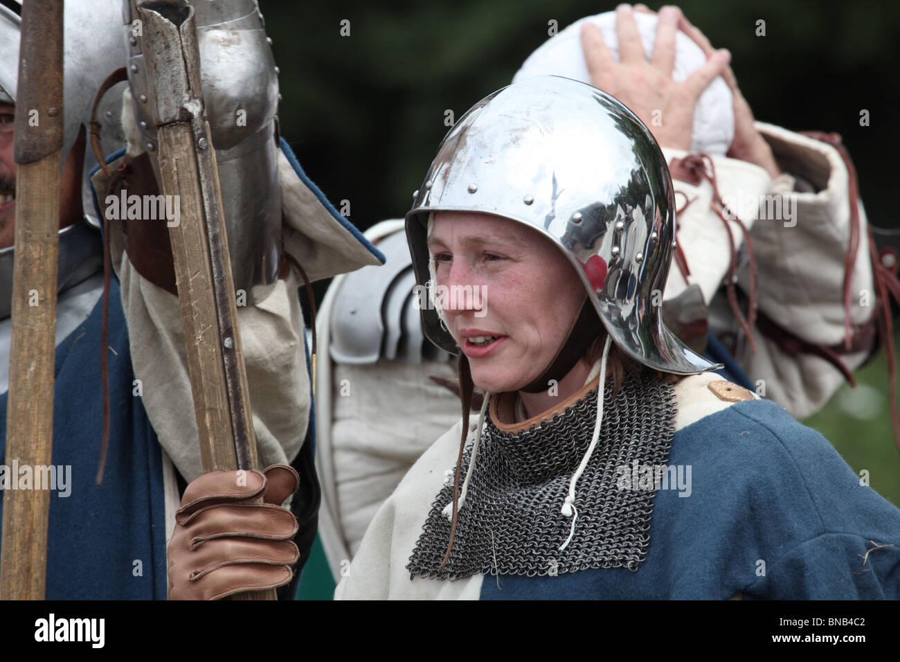 Mujer joven vestida con armadura medieval antes de la batalla de Tewkesbury Re-promulgación, 2010 Foto de stock