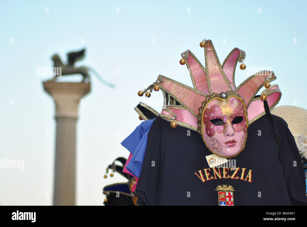 Máscara tradicional y león alado en la Plaza de San Marcos, en Venecia, Italia Foto de stock