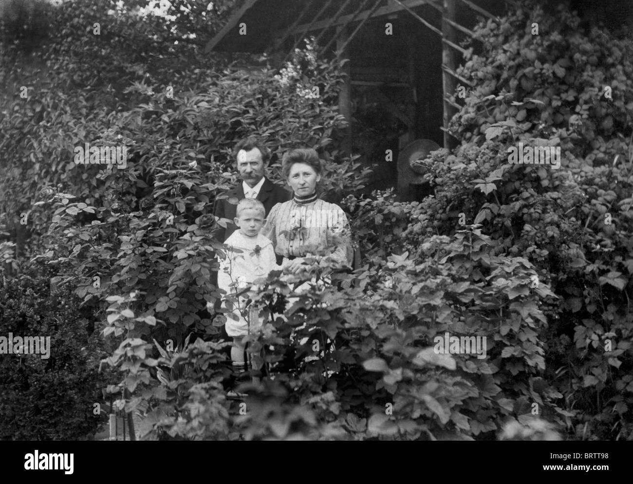 Familia en un jardín, imagen histórica, ca. 1930 Foto de stock