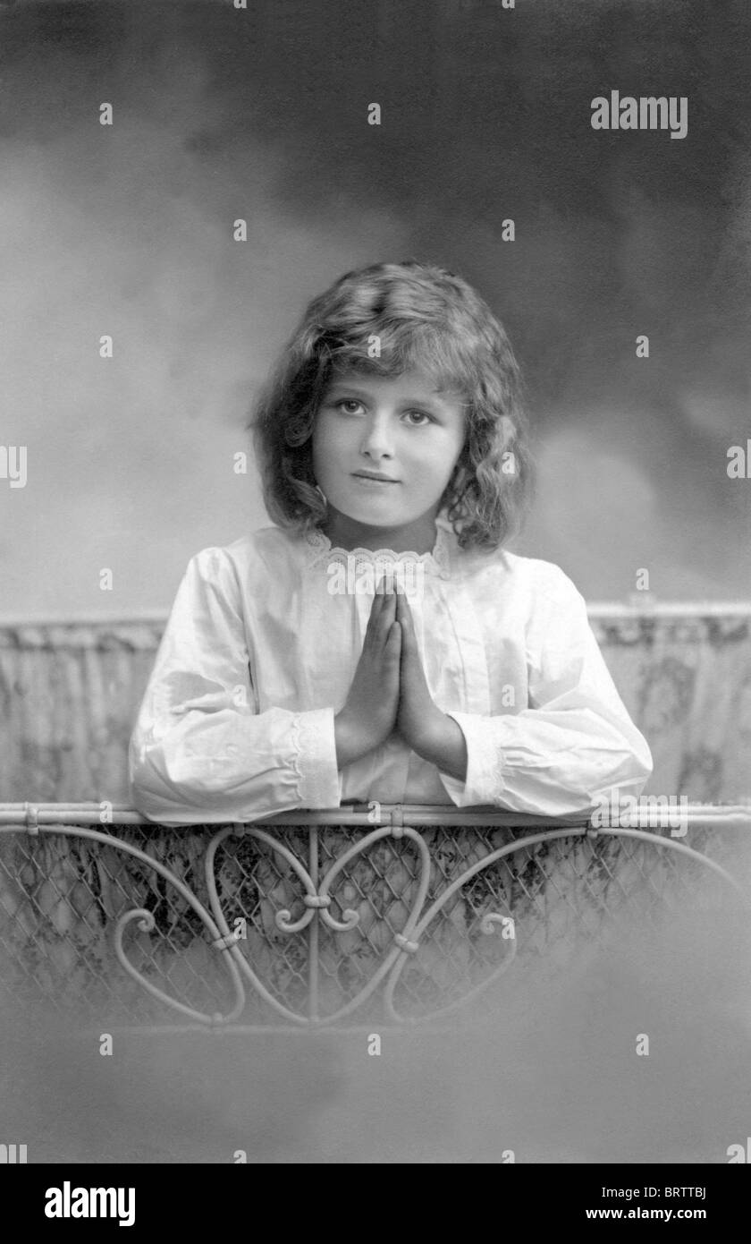 Niña rezando, imagen histórica, ca. 1912 Foto de stock