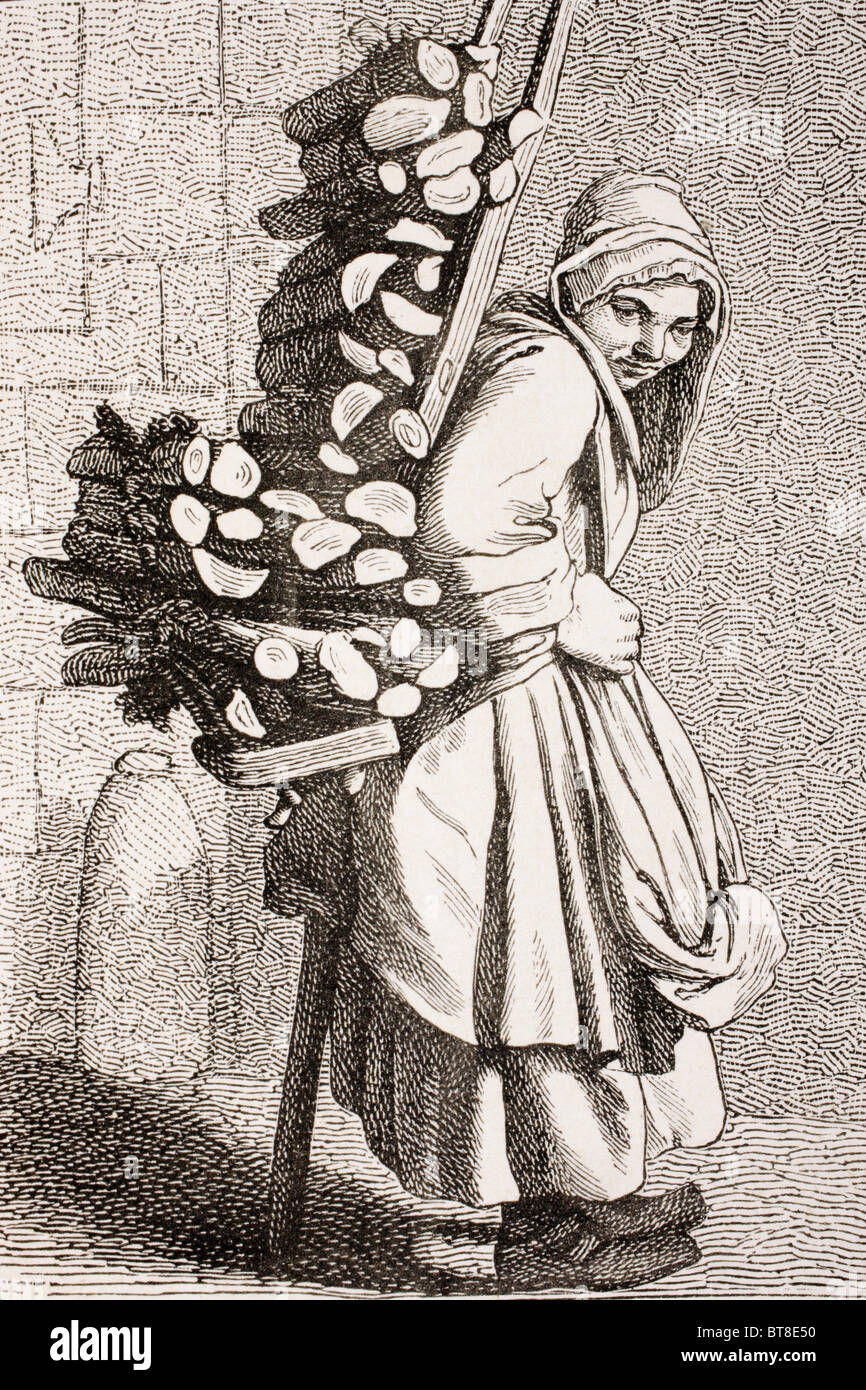 Una mujer llevando leña para venderla en el siglo XVIII en París. Foto de stock