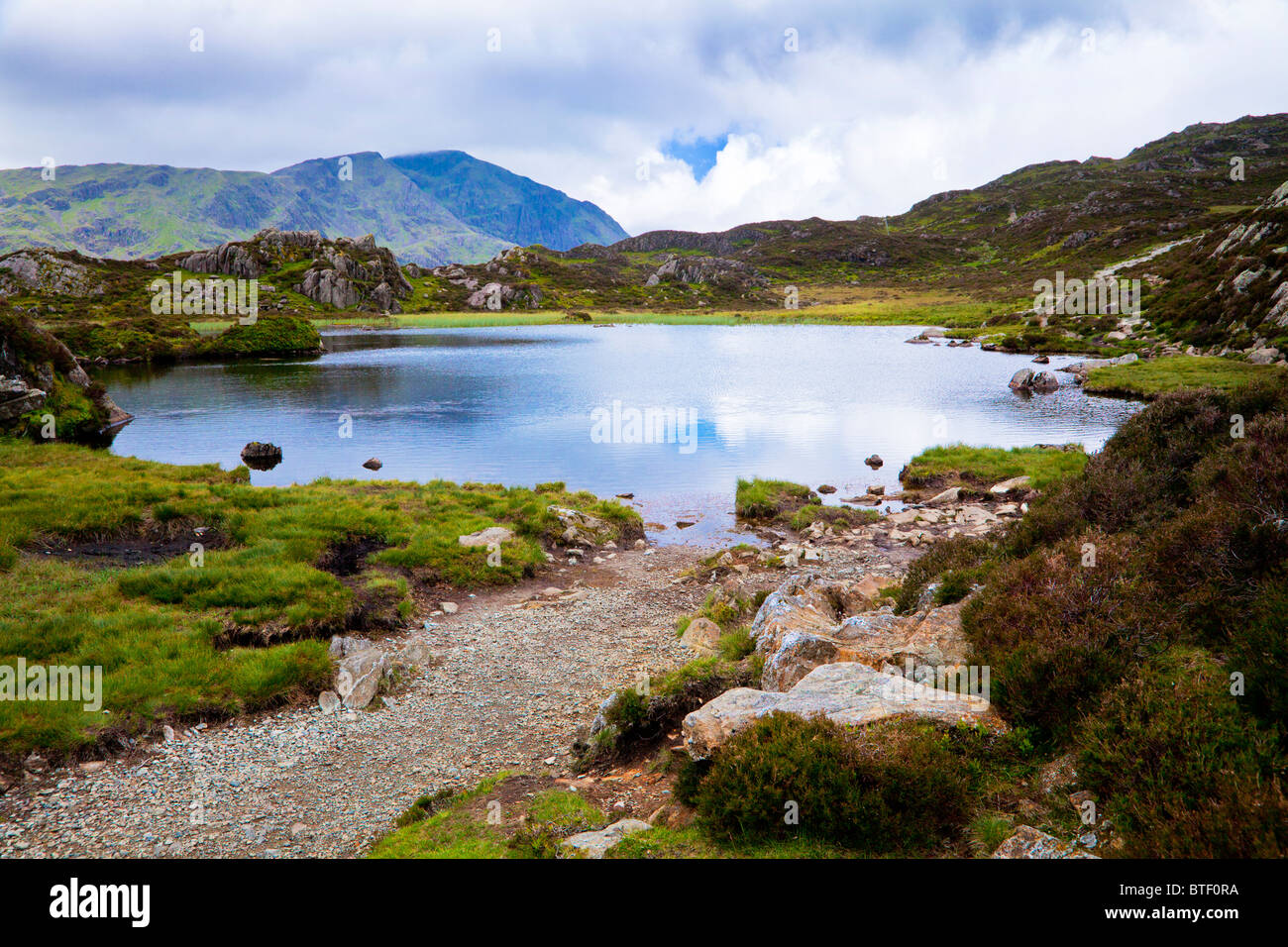 Hueso coxal Tarn, sobre la cumbre de un pajar en el Lake District, Cumbria, Inglaterra, Reino Unido. Foto de stock