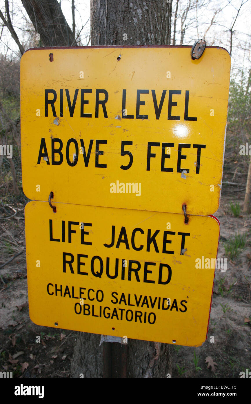 Señal de precaución bilingüe para el nivel del río en el río James. Virginia, EE.UU. Foto de stock