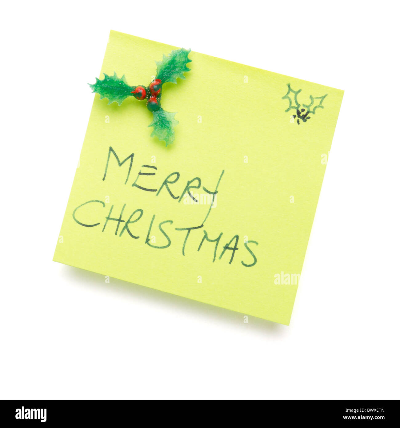 Feliz Navidad mensaje en post nota aislado en blanco. Foto de stock