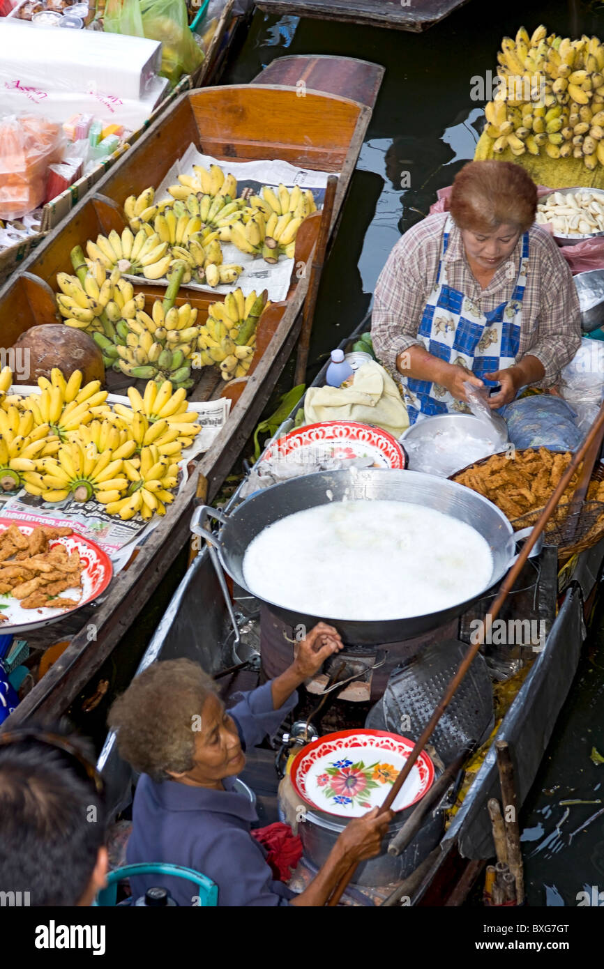 Las mujeres vendedoras en el mercado flotante de Damnoen Sakuak un khlong o long tail boat cerca de Bangkok, Tailandia Foto de stock