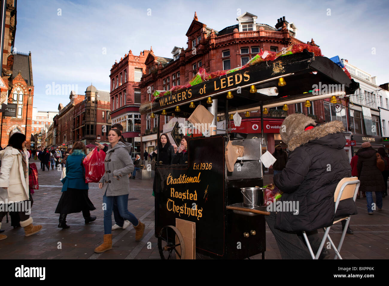 Reino Unido, Inglaterra, Yorkshire, Leeds, Briggate, caminantes de Leeds castañas asadas proveedor tradicional en Navidad Foto de stock