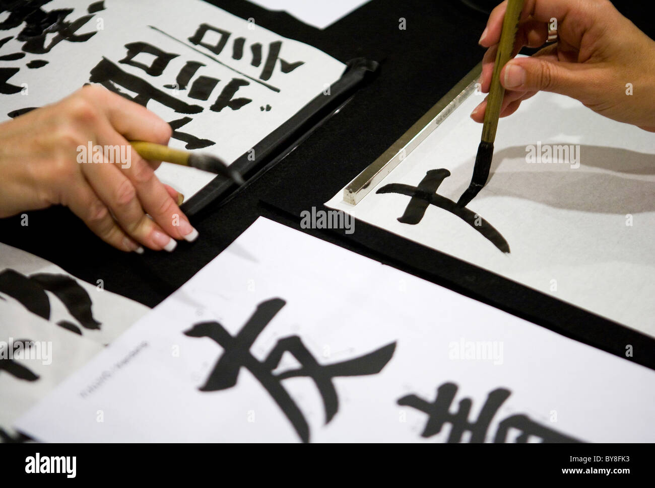 Estudiantes en una clase de caligrafía. Foto de stock