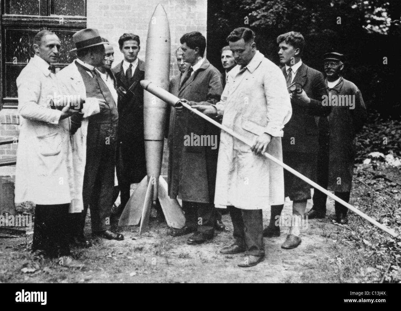 Klaus Riedel la celebración de una primera versión del cohete mínimo "Irak". Rudolph Nebel (izquierda), Franz Ritter (segundo desde la izquierda), Kurt Heinisch (izquierda del cohete), Hermann Oberth (quinta de la derecha), Klaus Riedel (delantero, en blanco), Wernher von Braun (segundo desde la derecha), 1930. ©Nasa/Cortesía Colección Everett Foto de stock