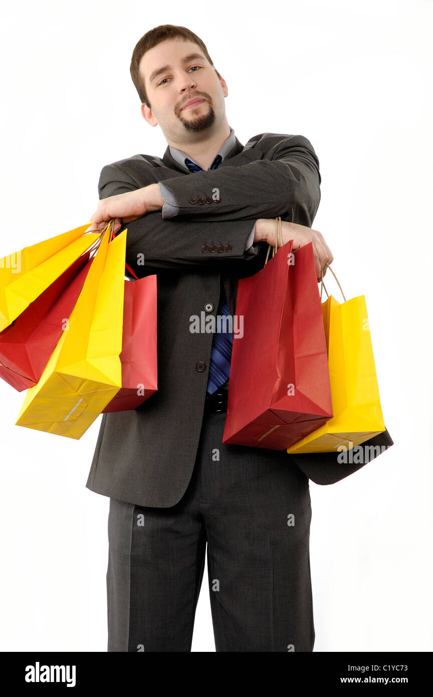 Hombre de negocios con muchas bolsas de compras, los brazos doblados,  buscando feliz, presuntuosos o satisfecho Fotografía de stock - Alamy