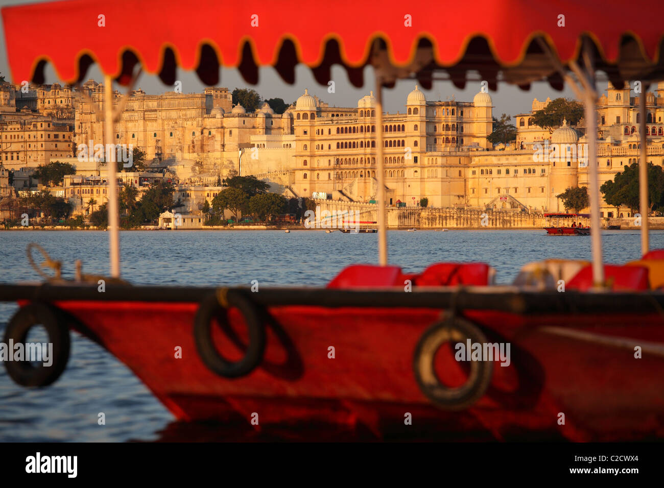 Ciudad de Udaipur con un turista en barco en el Lago Pichola, Udaipur, India Foto de stock