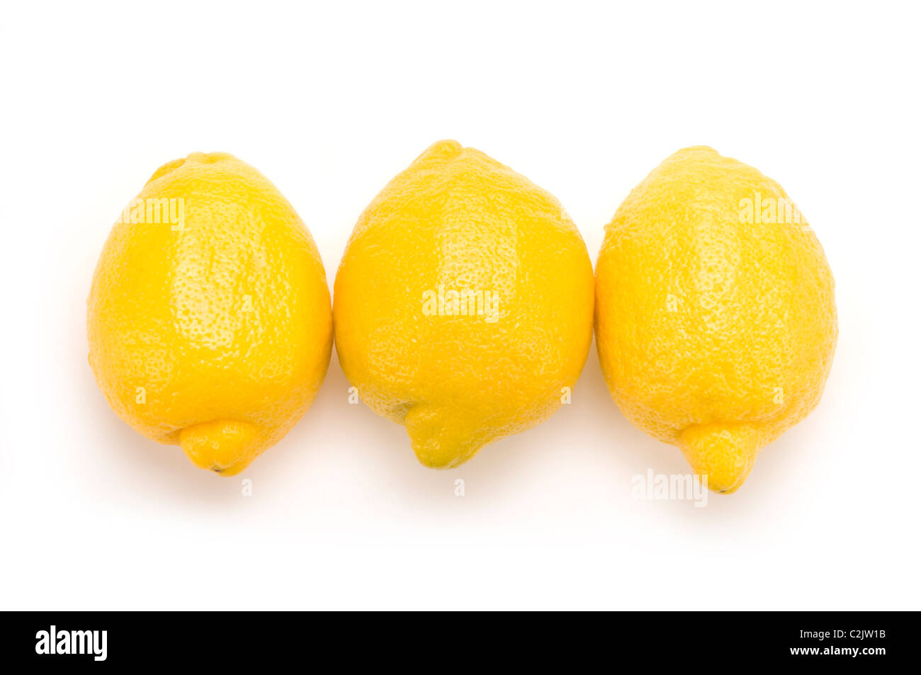 Tres limones en blanco Foto de stock