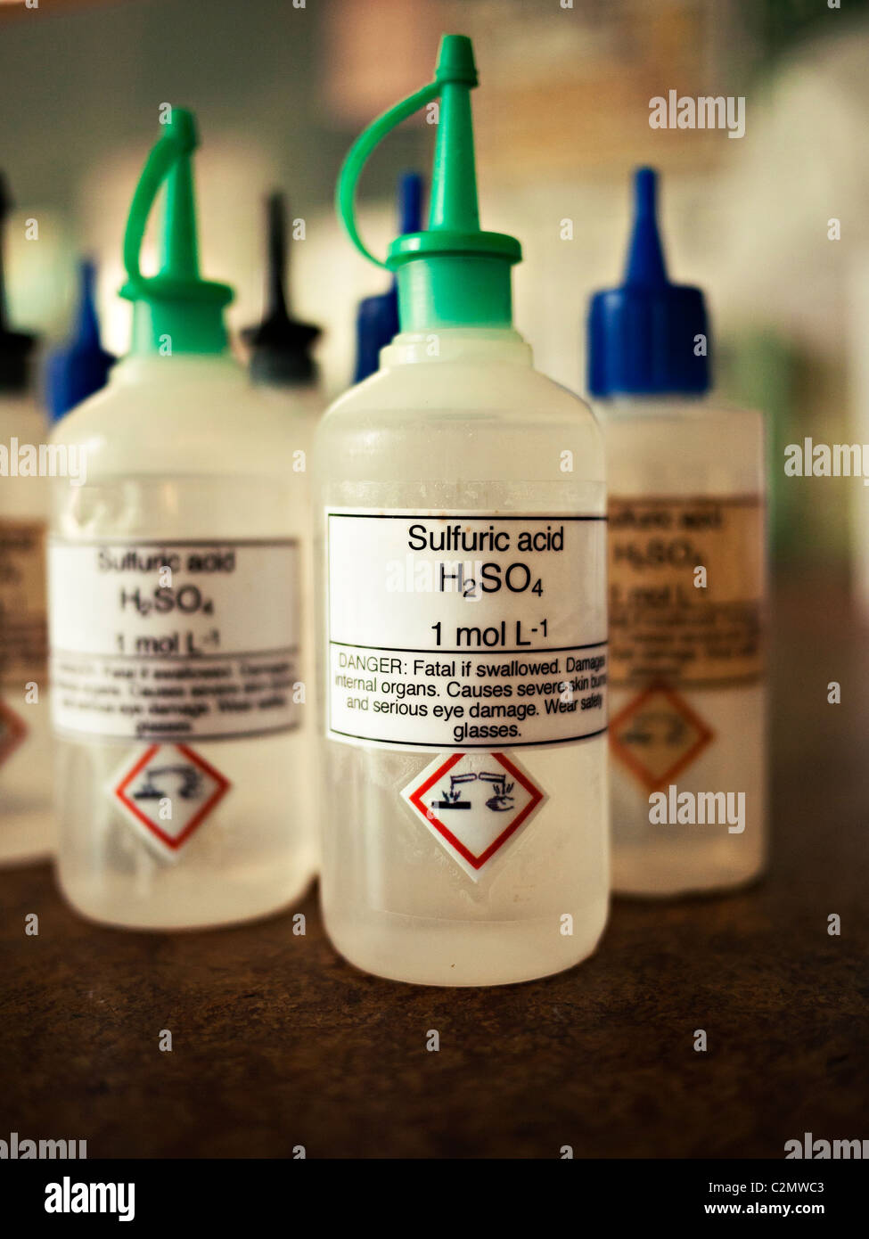 El ácido sulfúrico en el gotero de plástico, botellas de laboratorio escolar Foto de stock