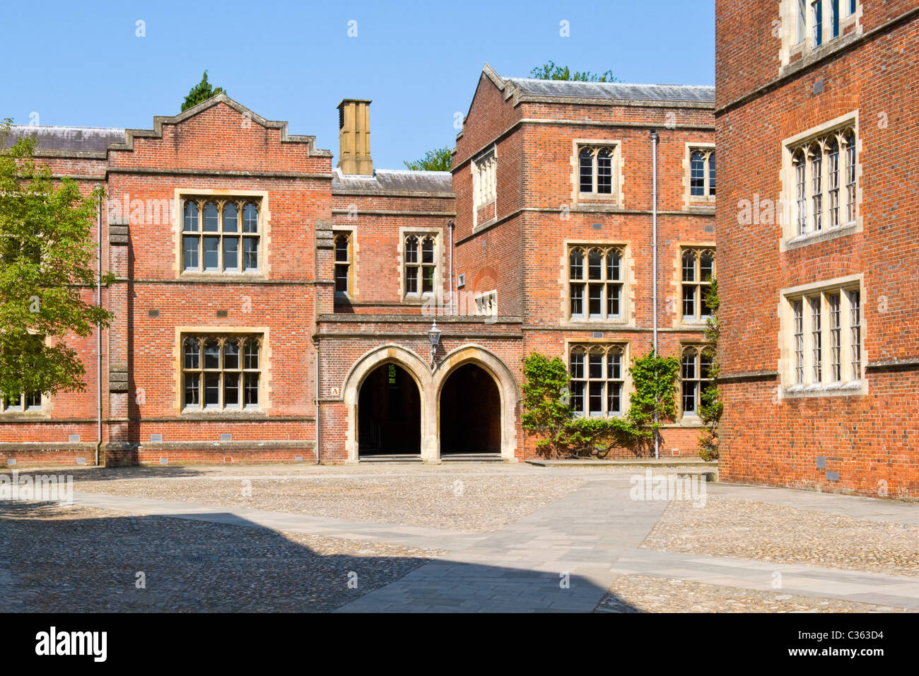 Winchester College fundada por carta de 1382 por el Obispo William de Wykeham patio de escuela de ladrillo rojo de cuatro edificios árboles árbol blue sky Foto de stock